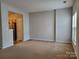 Spacious living room featuring neutral carpeting and lots of natural light at 7945 Mariners Pointe Cir, Denver, NC 28037