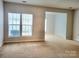 Large living room with neutral walls and carpet at 7945 Mariners Pointe Cir, Denver, NC 28037