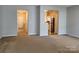 Open living room with a view into the kitchen and hallway at 7945 Mariners Pointe Cir, Denver, NC 28037