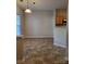 Simple dining area with light flooring and kitchen access at 7945 Mariners Pointe Cir, Denver, NC 28037