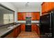 Modern kitchen with dark wood cabinets and black appliances at 137 Kensington St, Mooresville, NC 28117