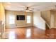 Living room with hardwood floors, fireplace, and TV at 9816 Cayenne Dr, Charlotte, NC 28214