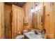 Simple bathroom with wood-paneled walls, a vanity, and a toilet at 5067 E Dixon Blvd, Kings Mountain, NC 28086