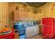 Rustic kitchen features wood cabinets, stainless steel appliances, and a red retro refrigerator at 5067 E Dixon Blvd, Kings Mountain, NC 28086