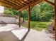 Covered patio overlooking wooded backyard at 1120 Red Porch Ln, Matthews, NC 28105