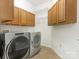 Laundry room with Whirlpool washer and dryer, cabinets, and shelving at 1120 Red Porch Ln, Matthews, NC 28105