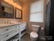 Double vanity bathroom with marble countertops and updated fixtures at 306 Sacco St, Belmont, NC 28012