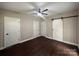 Spacious bedroom with dark hardwood floors, ceiling fan, and barn door at 306 Sacco St, Belmont, NC 28012