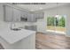 Modern kitchen with gray cabinets, island, and stainless steel appliances at 5151 Tommy Ln # 1103, Stanley, NC 28164