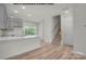 Modern kitchen with gray cabinets, island, and view of backyard at 5151 Tommy Ln # 1103, Stanley, NC 28164