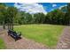 Community dog park with grassy area, benches, and waste disposal at 5151 Tommy Ln # 1103, Stanley, NC 28164