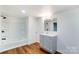 Updated bathroom with gray vanity, shower/tub combo, and wood-look floors at 5735 High Plains Ct, Iron Station, NC 28080