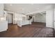 Open kitchen with island, white cabinets, and hardwood floors at 3192 Timber Run Ln, Maiden, NC 28650