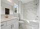 Modern bathroom with marble tile shower/tub combo and white vanity at 3192 Timber Run Ln, Maiden, NC 28650