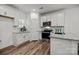 Modern kitchen with white cabinets, granite counters, and stainless steel appliances at 3108 Butler Hill Dr, Matthews, NC 28105