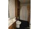 Bathroom with wood cabinets, shower, and colorful wallpaper at 106 Dons Ct, Shelby, NC 28150