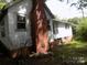 Rear view of a white home with brick chimney at 719 Mauney Rd, Stanley, NC 28164