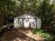 White wooden garage with double doors at 719 Mauney Rd, Stanley, NC 28164