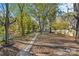 Large backyard with mature trees and a grassy area at 4319 Hovis Rd, Charlotte, NC 28208