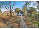 Spacious backyard with a brick pathway leading to the house at 4319 Hovis Rd, Charlotte, NC 28208