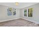 Well-lit bedroom with large windows and wood-look floors at 4319 Hovis Rd, Charlotte, NC 28208