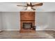 Living room featuring a brick fireplace and wood-look flooring at 511 Colorado Trl, Lincolnton, NC 28092