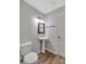 Updated bathroom with pedestal sink, wood-look flooring, and wainscoting at 511 Colorado Trl, Lincolnton, NC 28092