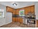 Updated kitchen featuring wood cabinets, stainless steel appliances, and tile backsplash at 511 Colorado Trl, Lincolnton, NC 28092