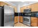 Stainless steel appliances and wood cabinets in this galley kitchen at 211 N Dotger Ave # D-3, Charlotte, NC 28207