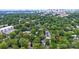 Aerial view showing the community with tree-lined streets and a city skyline in the distance at 211 N Dotger Ave # D-3, Charlotte, NC 28207