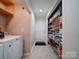 Laundry Room with Maytag washer and dryer, shelving, and pantry access at 4616 Canal Rd, Marshville, NC 28103