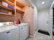 Laundry room with Maytag washer and dryer and additional shelving at 4616 Canal Rd, Marshville, NC 28103