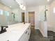 Modern bathroom with double vanity, large mirror, and walk-in shower at 1110 Lowland Way, Waxhaw, NC 28173