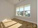 Bright home office features large windows with neighborhood views and light hardwood floors at 1110 Lowland Way, Waxhaw, NC 28173