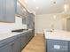 Modern kitchen with gray cabinets, quartz countertops and island at 1110 Lowland Way, Waxhaw, NC 28173