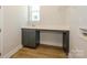Laundry room with gray cabinets, quartz countertop, and built-in shelving at 1110 Lowland Way, Waxhaw, NC 28173