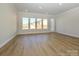 Bright living room with hardwood floors and large windows offering natural light at 1110 Lowland Way, Waxhaw, NC 28173