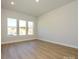Spacious office featuring hardwood floors and three large windows at 1110 Lowland Way, Waxhaw, NC 28173