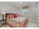 Primary bedroom with a floral comforter and red and white striped pillows at 15417 Cimarron Hills Ln, Charlotte, NC 28278