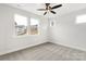 Bright bedroom with ceiling fan, carpet, and large windows at 440 Nathaniel Way # Brx0041, Charlotte, NC 28213