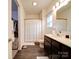 Clean bathroom with dark vanity, shower, and walk-in closet at 165 Old Harbor Dr, Mount Gilead, NC 27306