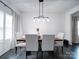Dining room with light gray chairs, wood table, and modern light fixture at 165 Old Harbor Dr, Mount Gilead, NC 27306