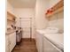 Bright laundry room with washer, dryer, and extra storage at 165 Old Harbor Dr, Mount Gilead, NC 27306