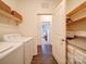 Laundry room with washer, dryer, shelving, and extra counter space at 165 Old Harbor Dr, Mount Gilead, NC 27306