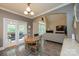 Bright dining area with hardwood floors, access to a deck, and open to living room at 1936 46Th Avenue Ne Dr, Hickory, NC 28601