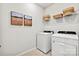 Laundry room with washer, dryer, and shelving at 7055 Stella Pl, Stanley, NC 28164