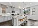 Modern kitchen with gray cabinets, island, and pendant lights at 7055 Stella Pl, Stanley, NC 28164