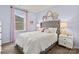 Bright bedroom with a gray upholstered bed, window with curtains, and decorative mirrors at 7055 Stella Pl, Stanley, NC 28164
