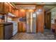 Kitchen with wood cabinets, stainless steel refrigerator, and tile floor at 4537 Sunrise Beach Rd, Catawba, NC 28609