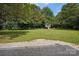 Large backyard with grassy area, playset, and plenty of space for outdoor activities at 1029 Churchill Rd, Davidson, NC 28036